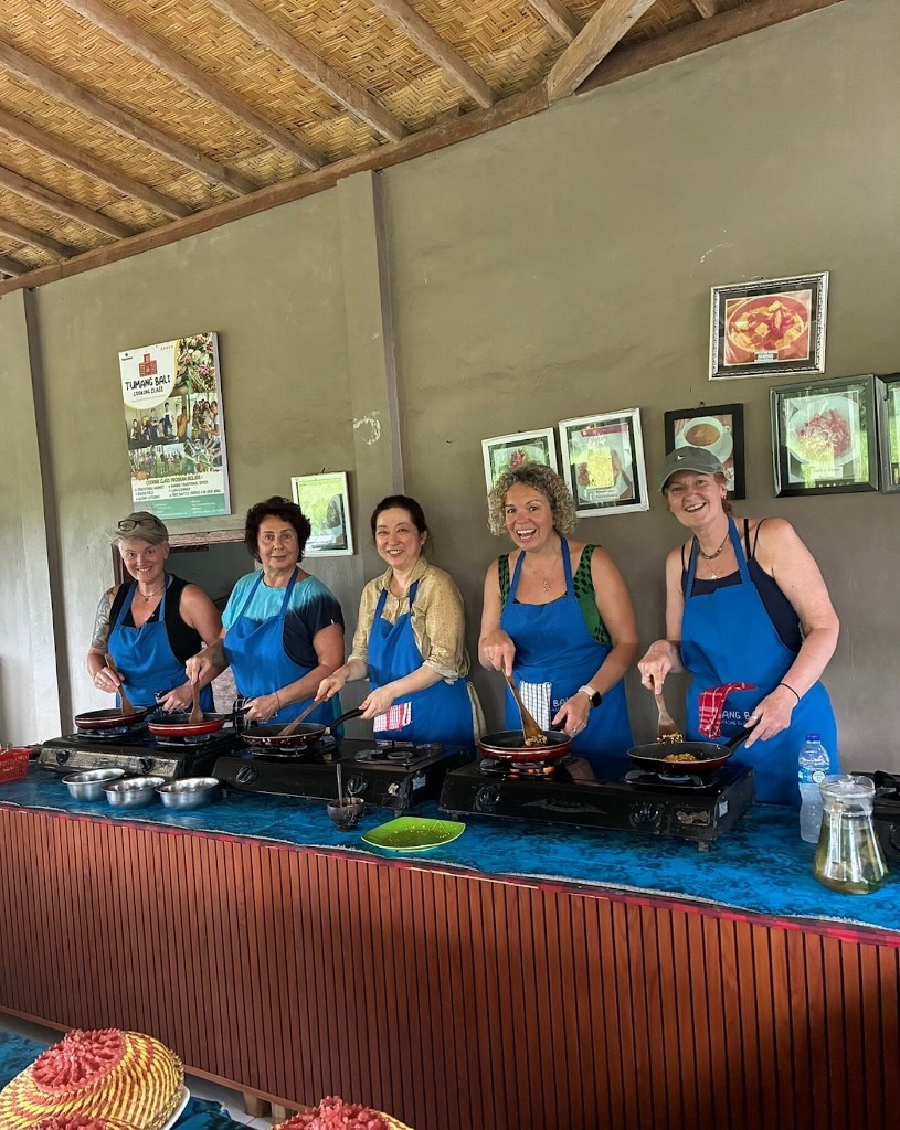 Guests cooking at individual stations in the village kitchen